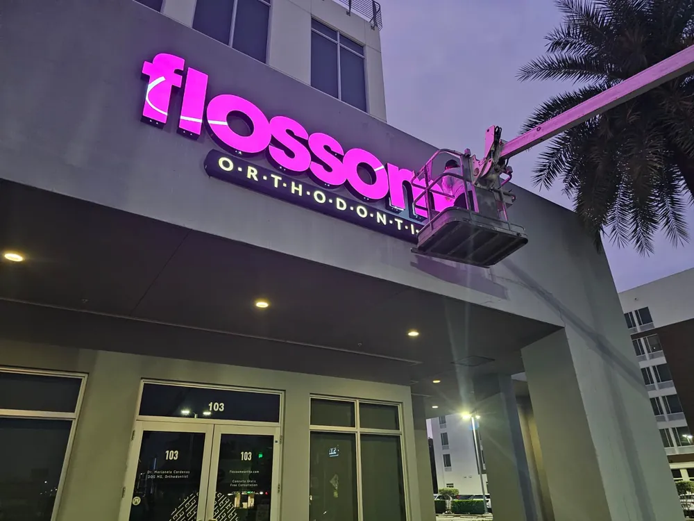 Spazio Design crew installing illuminated channel letters on a building in Doral